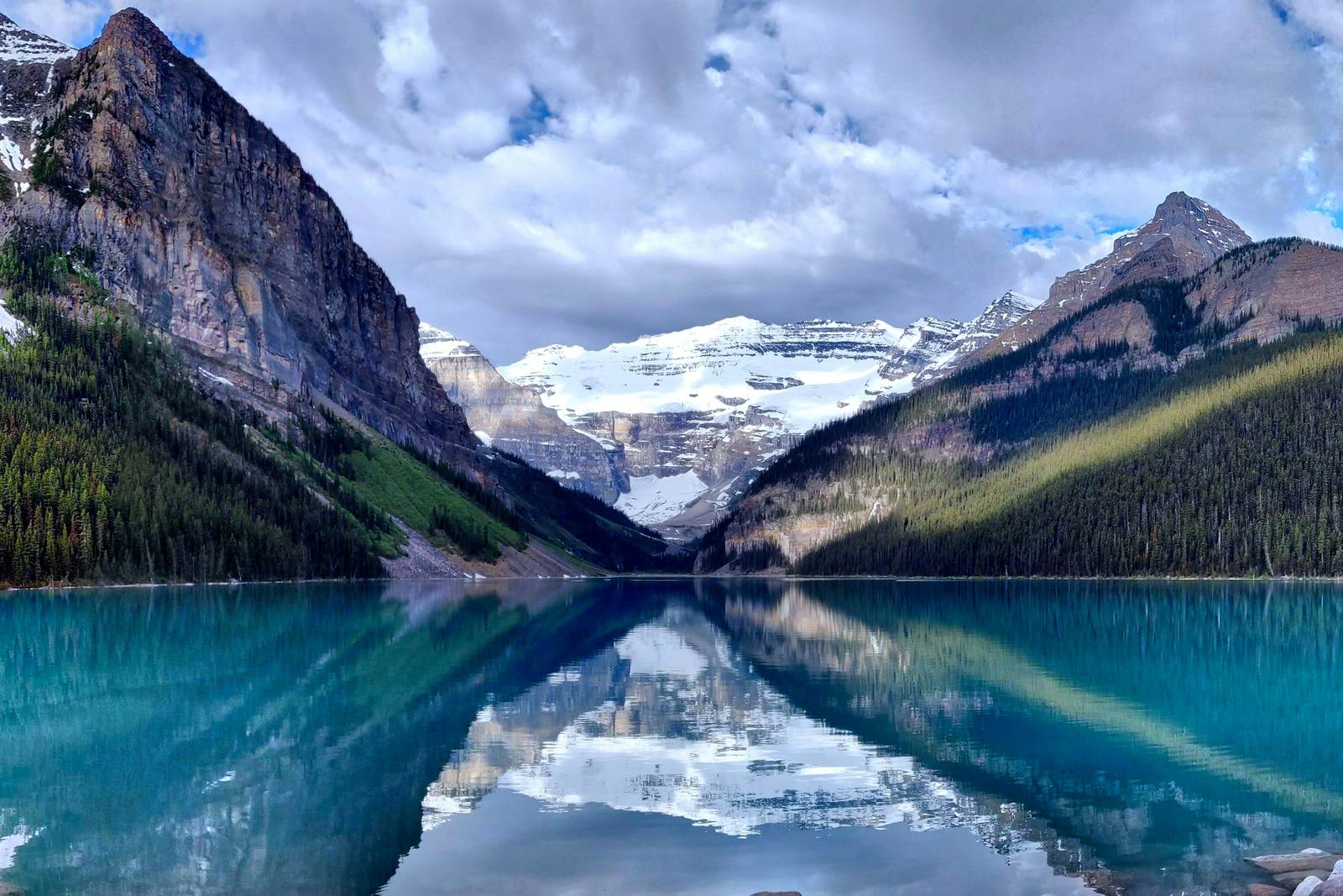 Lake Louise with mountains and glacier reflected in turquoise water