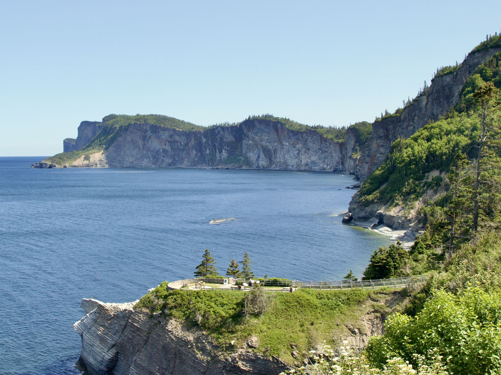 Steep coastal cliffs and a lookout above the sea in Forillon National Park
