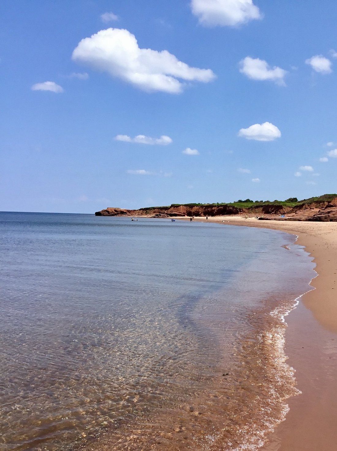 Clear shallow water and a red-sand beach on Prince Edward Island