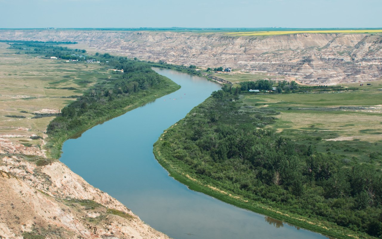 The Red Deer River winding through green badlands near Drumheller