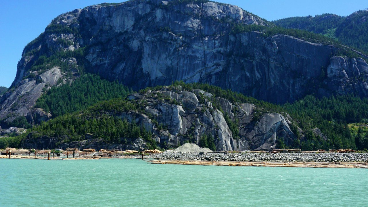 The Stawamus Chief granite monolith rising above turquoise water at Squamish, on the Sea-to-Sky Highway